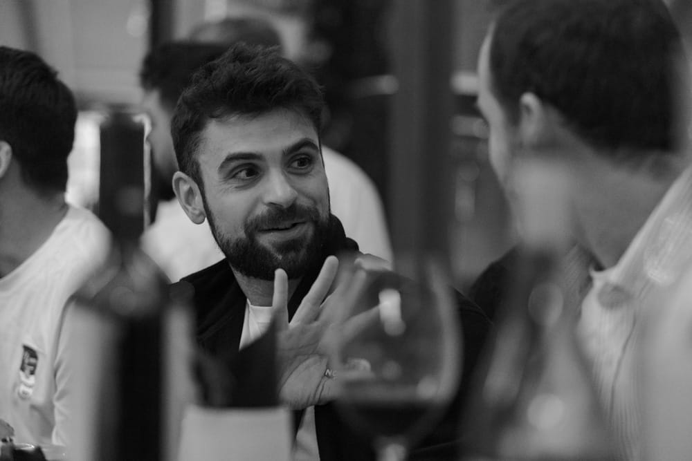 A photograph of a GitBook team member enjoying an espresso in a sunny environment
